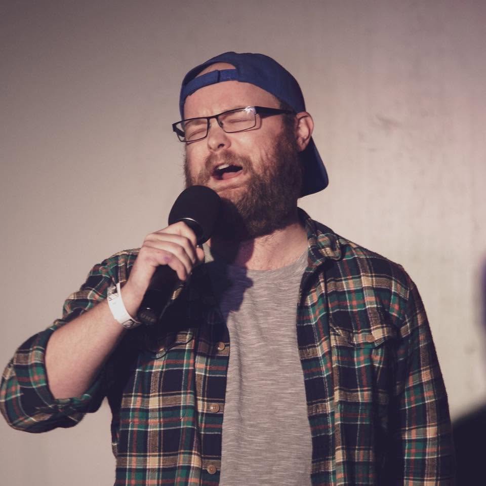 Andrew Boydston performing stand-up comedy on stage